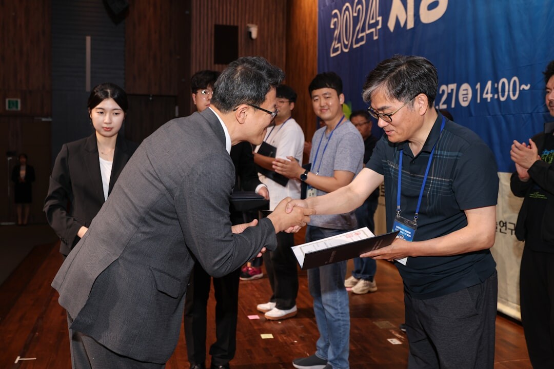 Two executives shaking hands after signing an agreement