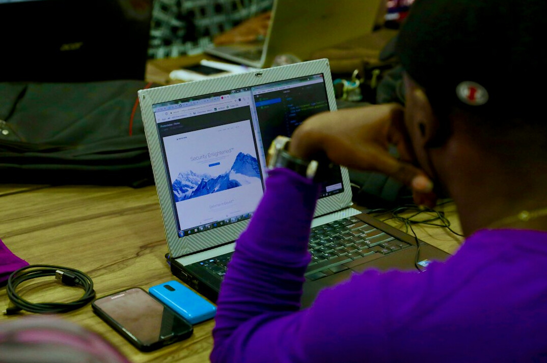 children and adults in coding class